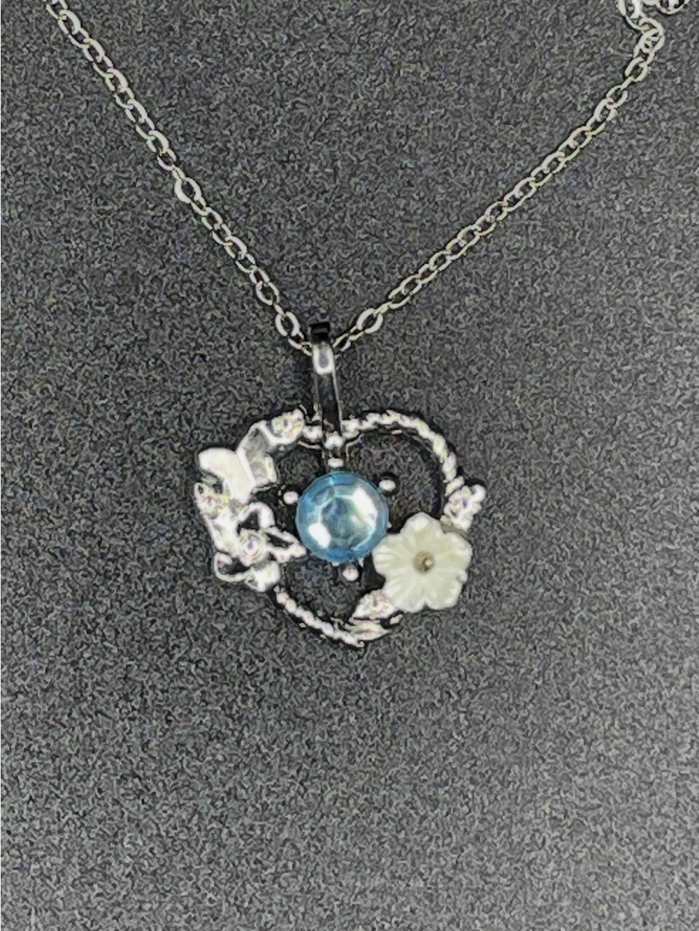 Silver Colored Heart Necklace w/White Flower, Silver Butterfly, and Blue Stone